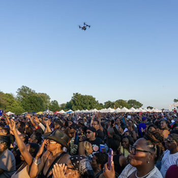 Drone flying over an enthusiastic crowd at the Chosen Few Picnic