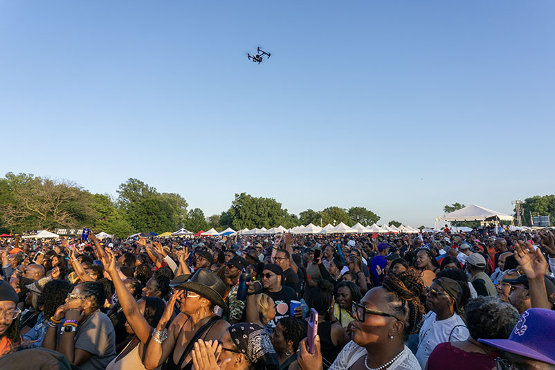 Drone flying over an enthusiastic crowd at the Chosen Few Picnic